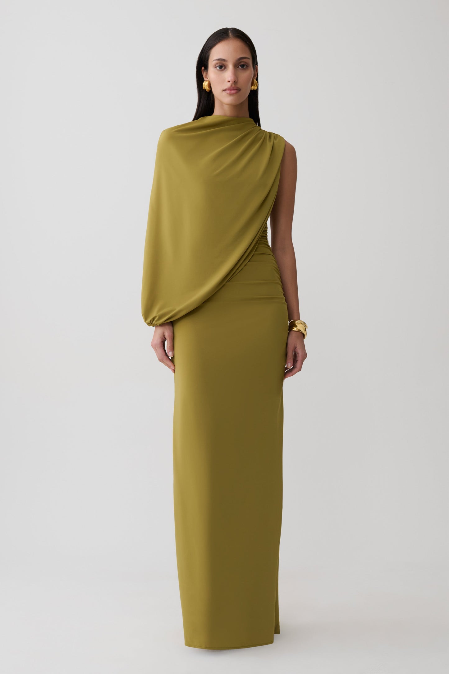 Woman wearing a green gather sleeve maxi dress.