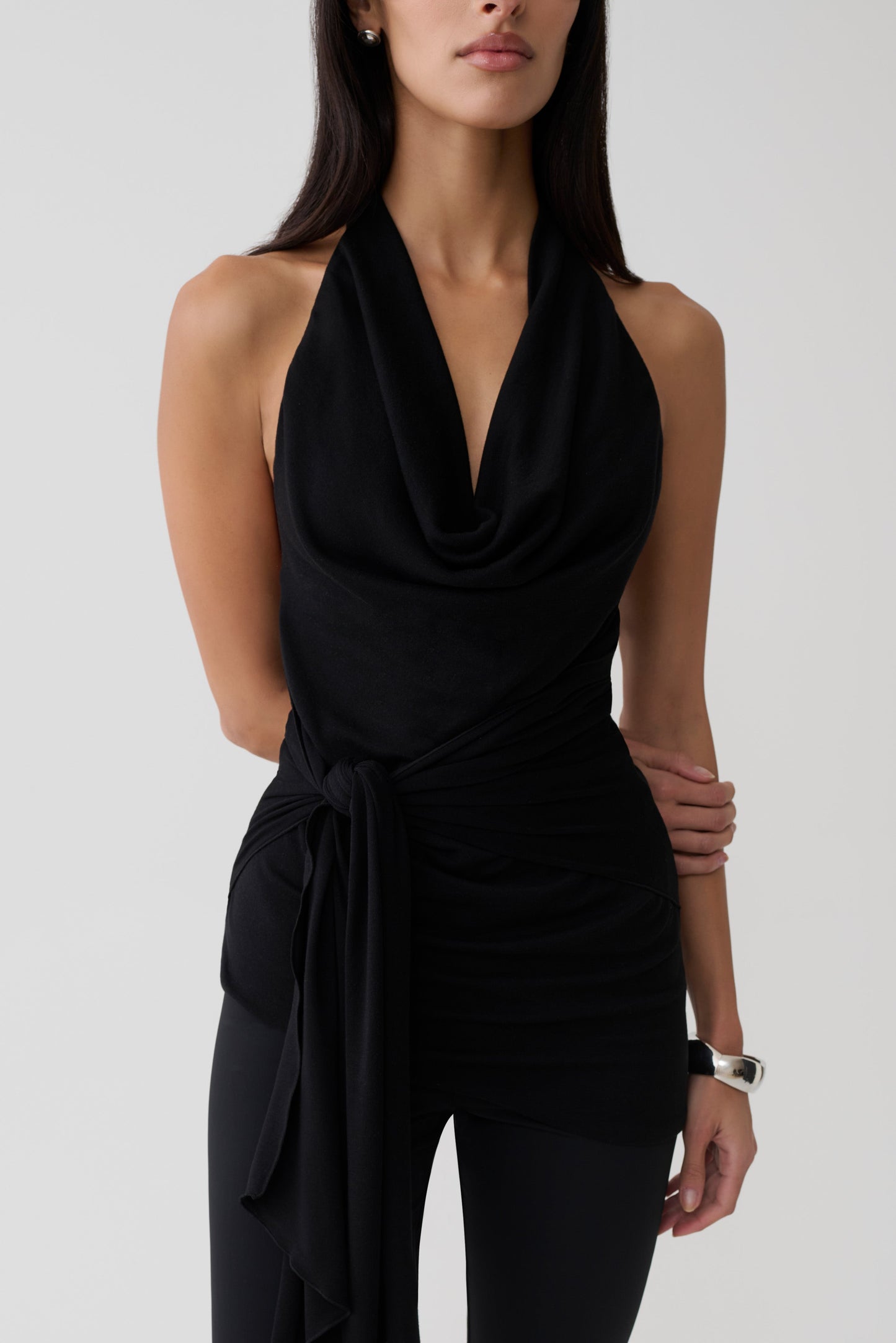 Woman wearing a black front tie halter top.