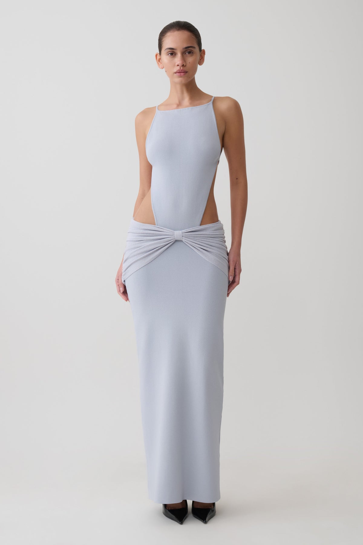 Woman wearing a light blue sleeveless maxi dress.