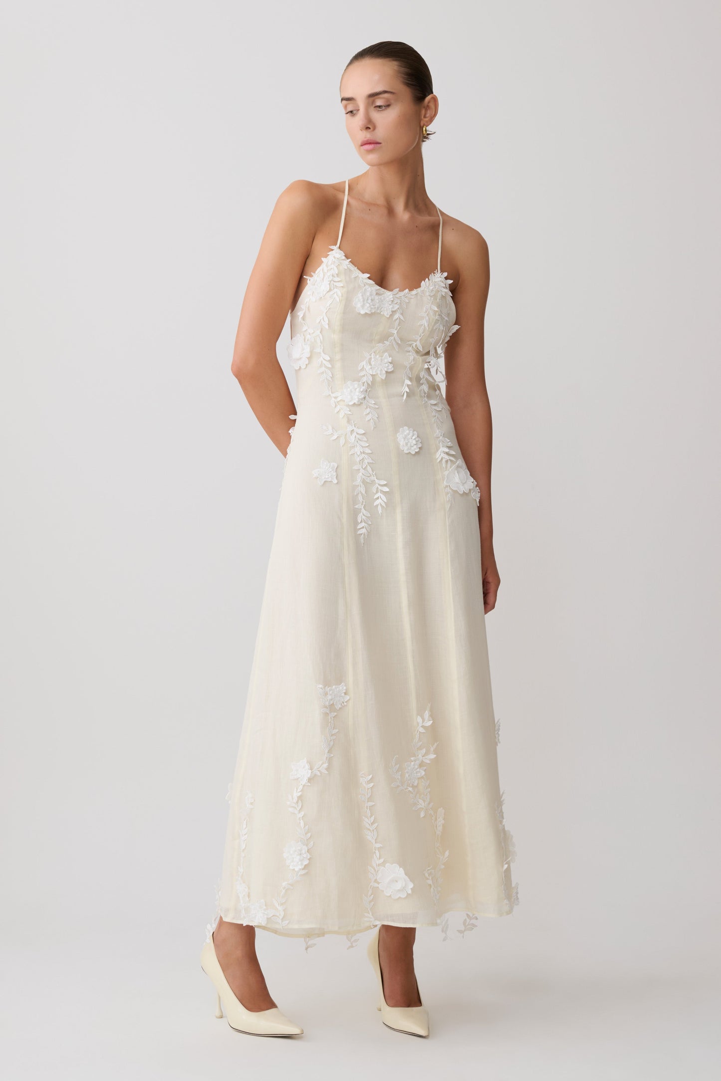 Woman wearing a white floral maxi dress.