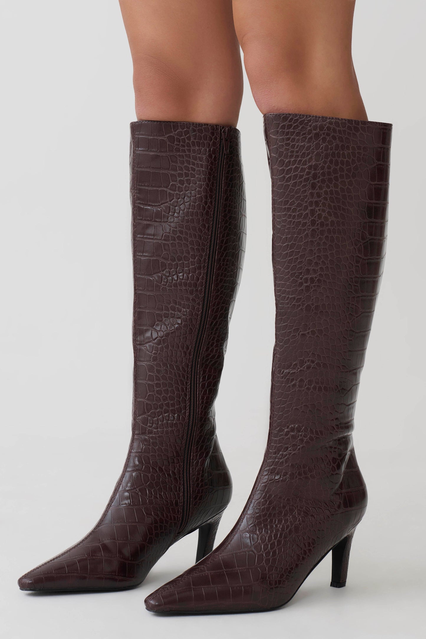 Brown knee-high boots with a textured pattern.