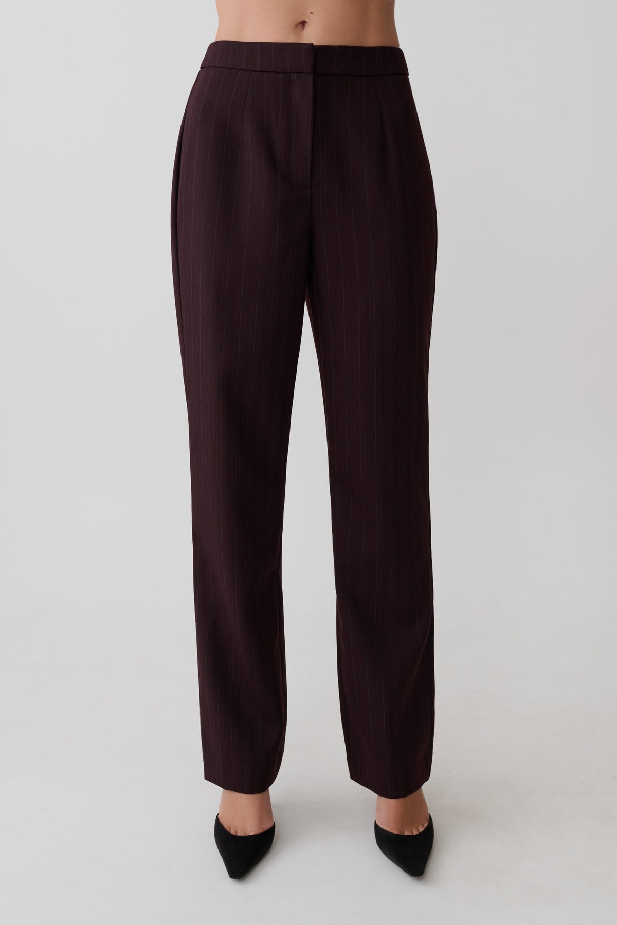 Women wearing dark brown striped pants.