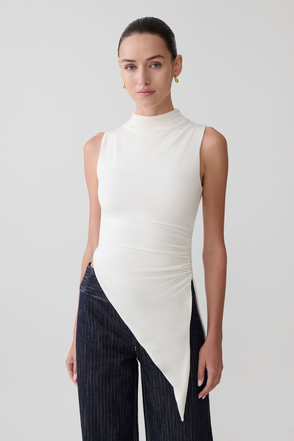Woman wearing a black sleeveless top.
