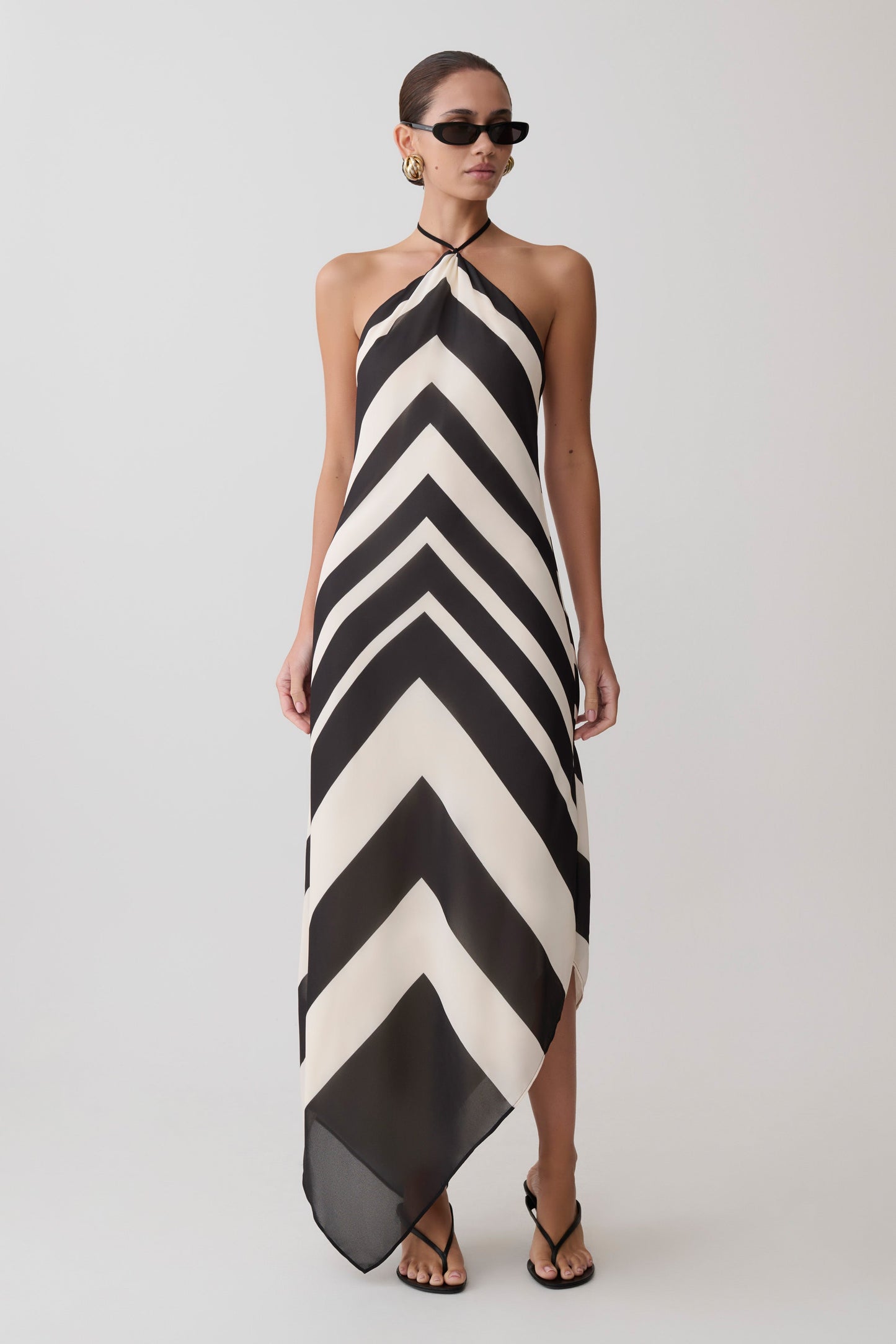 Woman wearing a black and white chevron patterned dress.