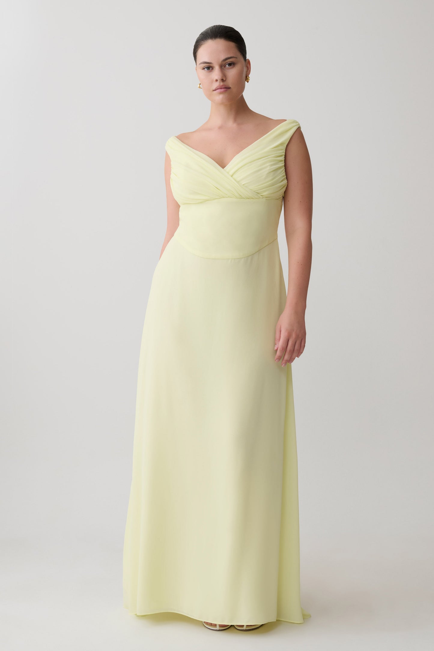 Woman wearing a light yellow evening gown.