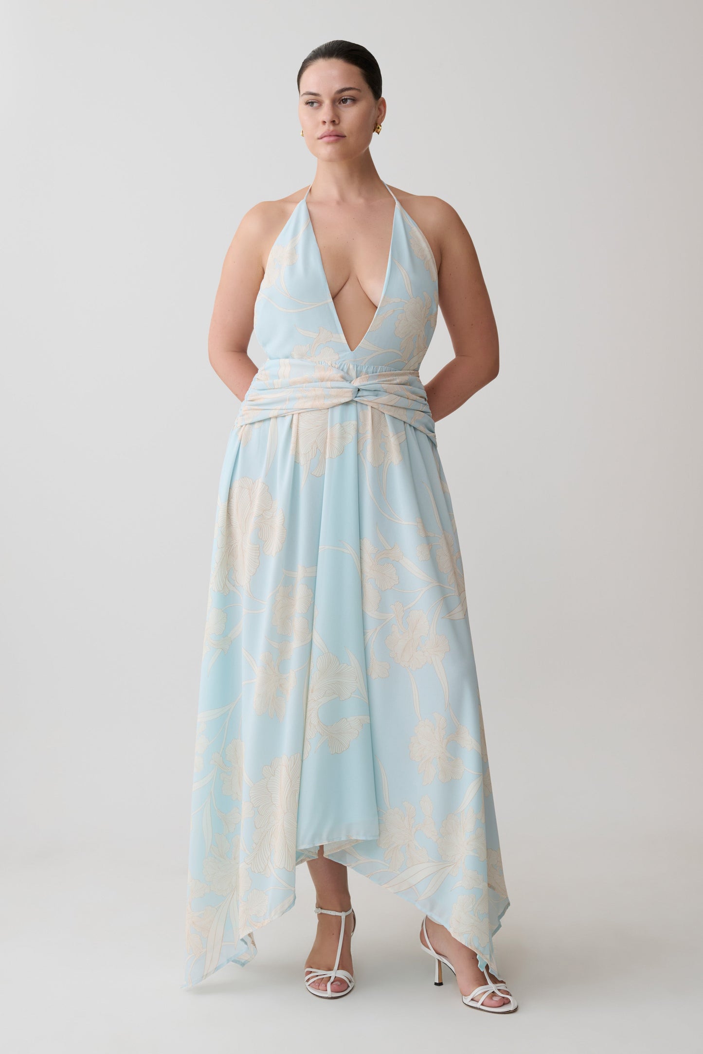 Woman wearing a light blue and white floral dress.