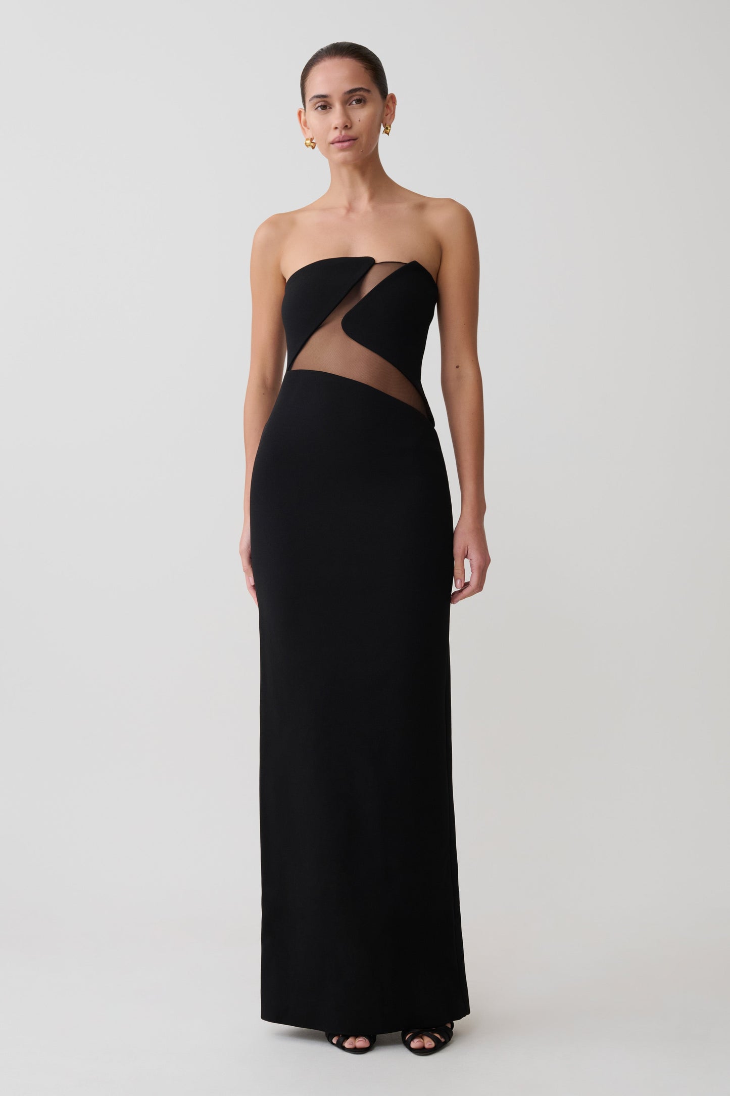 Black strapless gown with cut-out design on a white background