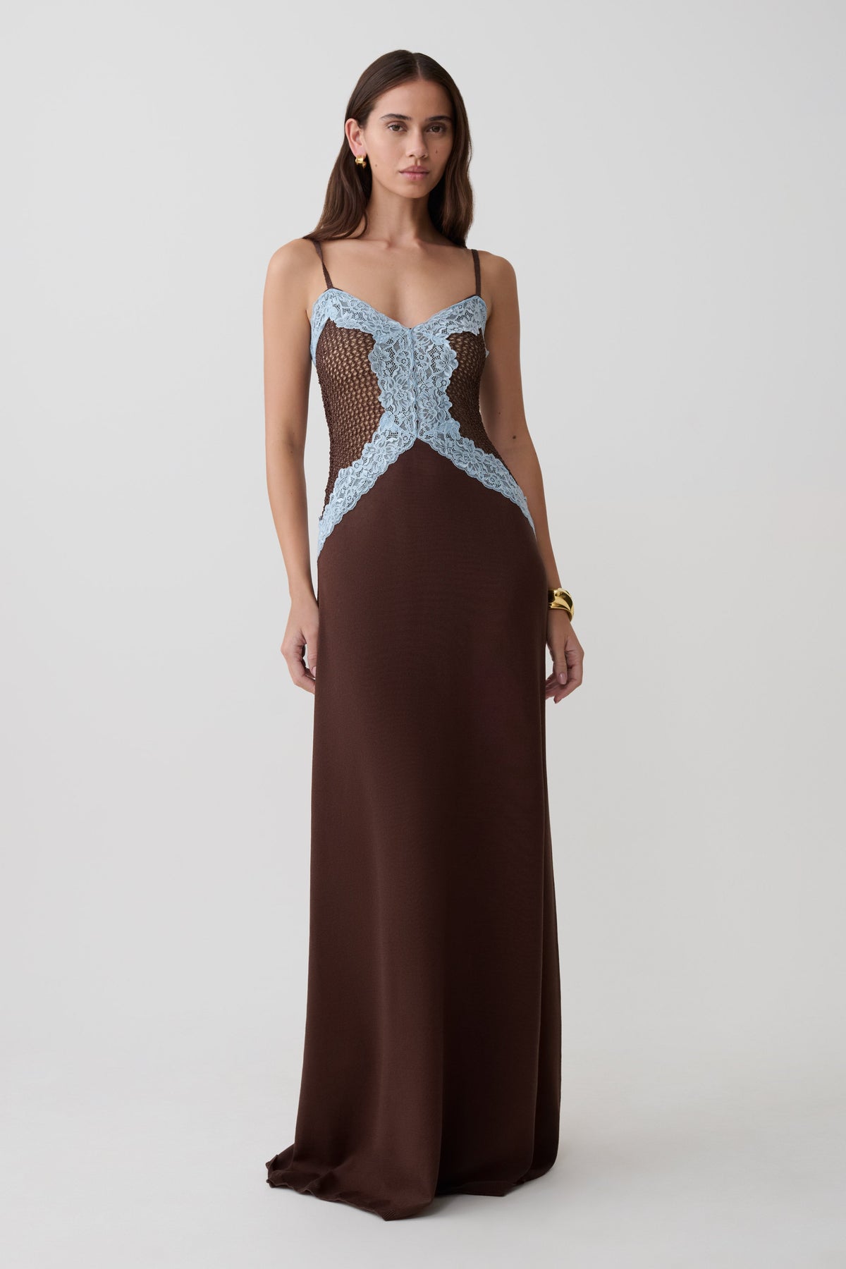 Woman wearing a brown and blue knit and lace maxi dress.
