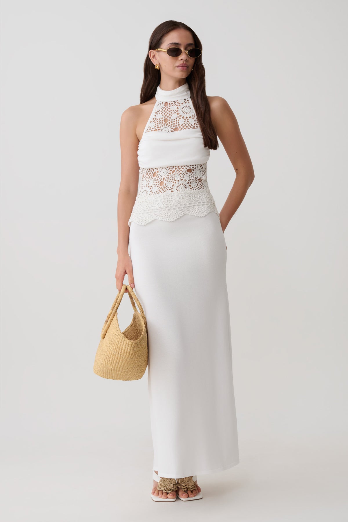 Woman wearing a knit and crochet maxi dress.