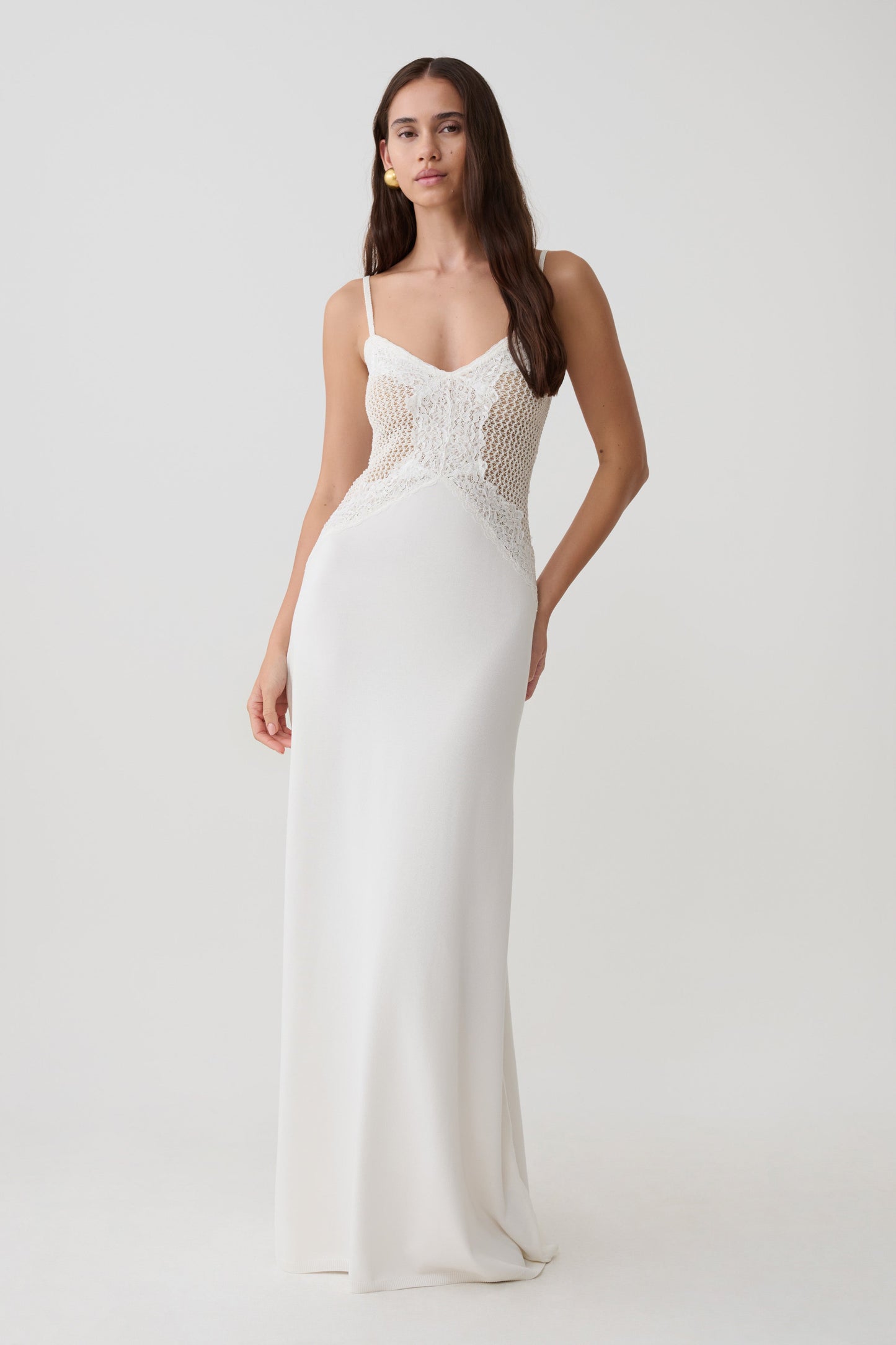 Woman wearing a knit and lace maxi dress.