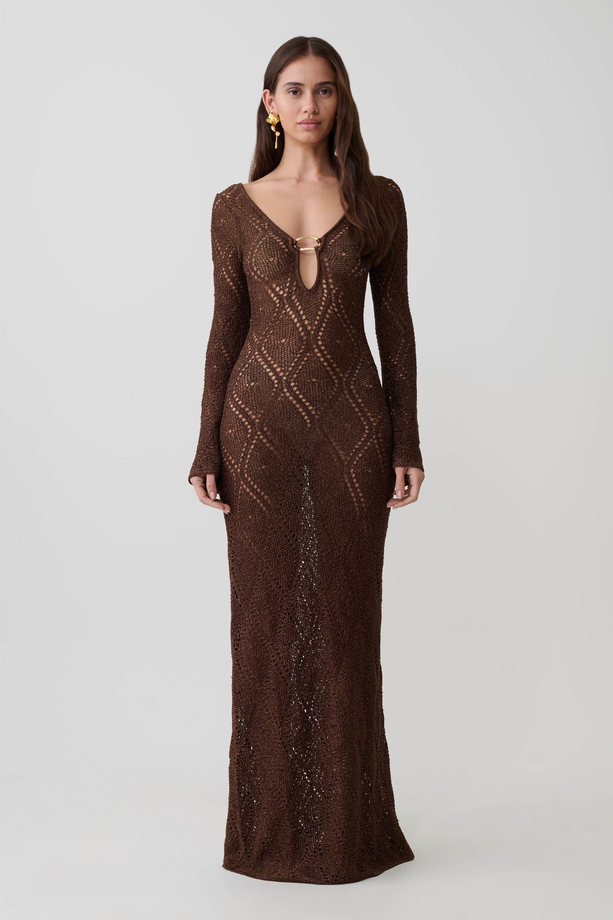 Woman wearing a brown lurex crochet long-sleeve dress.