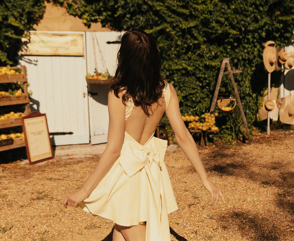 Image of woman in lemon sherbet mini dress.