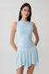 Woman wearing a light blue sleeveless tank top.