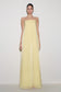 Woman wearing light yellow strapless maxi dress.