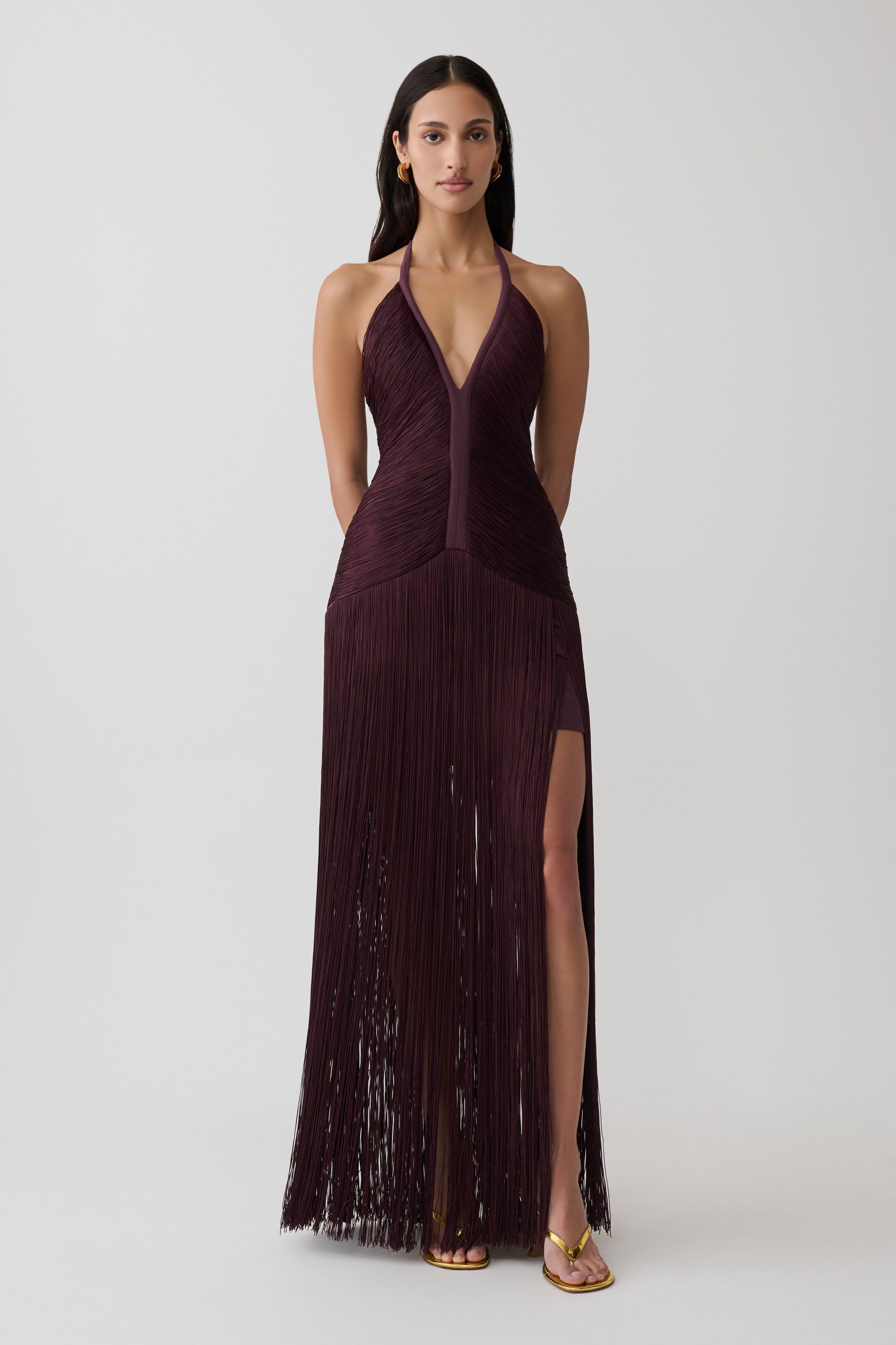 Woman wearing a purple fringe maxi dress.