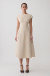 Woman wearing a beige linen cap sleeve midi dress.
