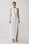 Woman wearing a white halter neck top with hardware witthe matching midi skirt.