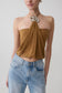 Woman wearing a caramel halter top with hardware.