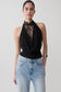 Woman wearing a black chiffon & lace halter top.