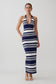Woman wearing a navy and white striped maxi dress.
