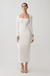 Woman wearing a white long sleeve wool midi dress.