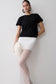 Woman wearing a black t-shirt and white organza maxi skirt.