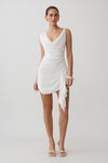 Woman wearing a white cowl drape satin mini dress.