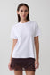 Woman wearing a white cotton oversized t-shirt.
