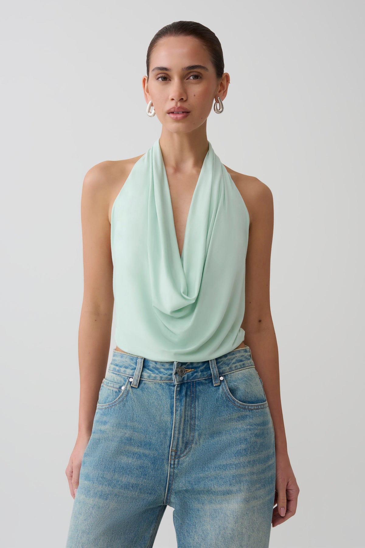 Woman wearing a light blue cowl front modal top.