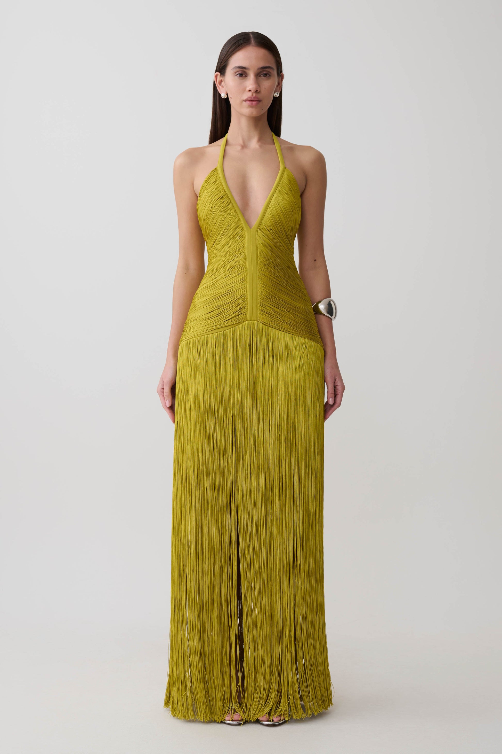 Woman wearing a green fringe maxi dress.