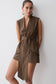 Woman wearing a brown striped waist tie sleeveless top.