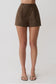 Woman wearing brown striped pintuck cotton shorts.