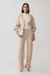 Woman wearing beige knit cuffed wide leg pants.