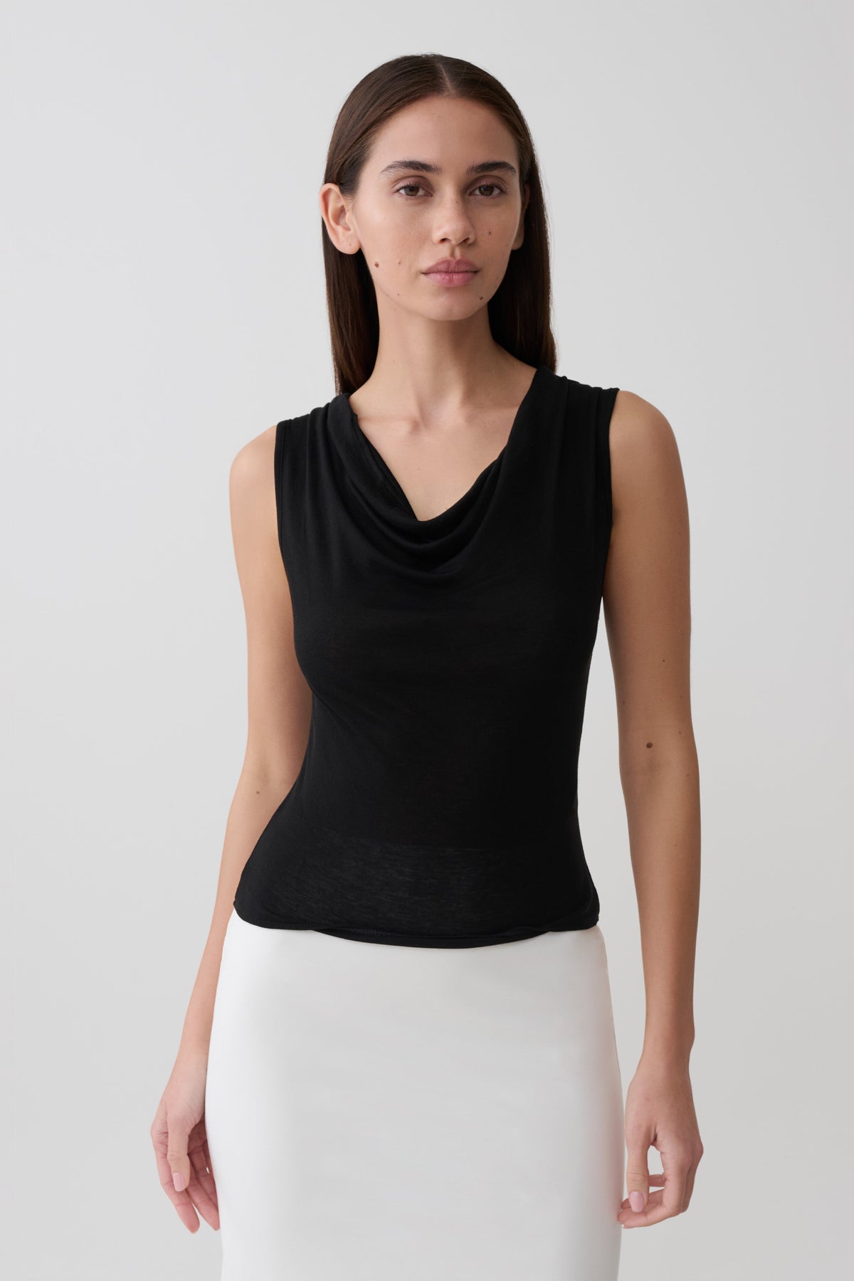 Woman wearing black sleeveless sheer top.