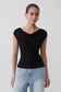 Woman wearing a black sleeveless sheer top.