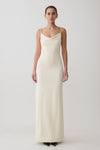 Woman wearing a white cowl maxi dress.