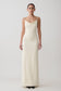 Woman wearing a white cowl maxi dress.