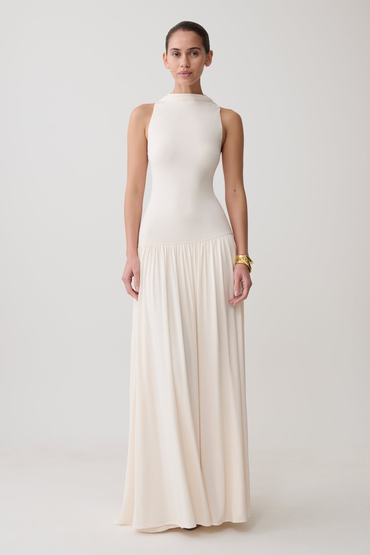 Woman wearing a white high neck modal maxi dress.