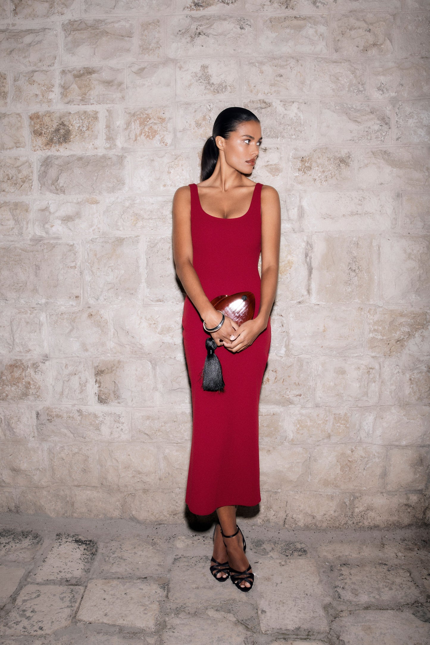Woman wearing a red crepe midi dress.