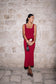 Woman wearing a red crepe midi dress.