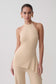 Woman wearing a beige longline knit top.