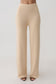 Woman wearing beige knit pants.