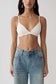 Woman wearing white micro triangle bralette.