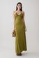 Woman wearing a green gathered slinky maxi dress.