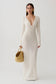 Woman wearing a white crochet knit maxi dress.
