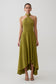 Woman wearing a green twisted neck dry jersey bodysuit with matching maxi skirt.