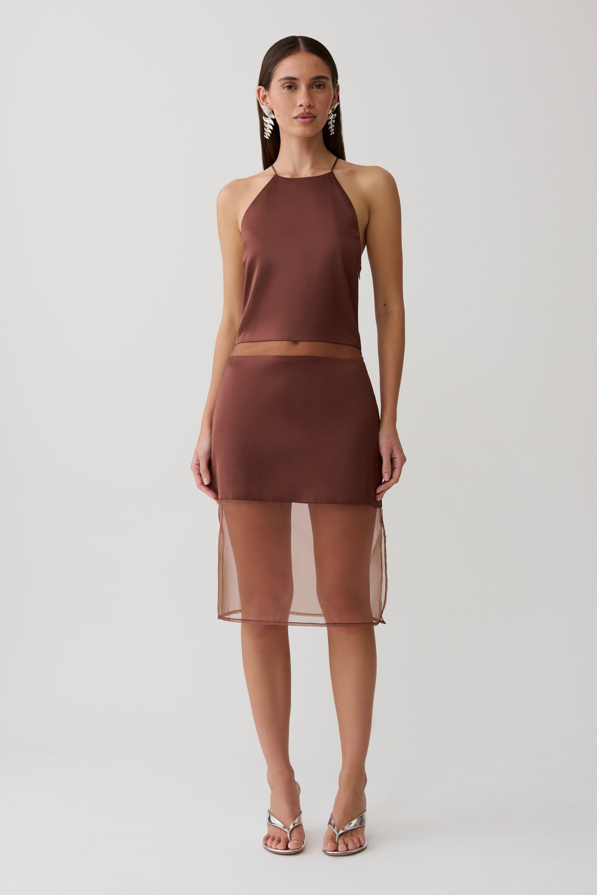 Woman wearing a brown sheer halter midi dress.