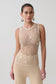 Woman wearing a beige pearl beaded top.