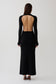 Woman wearing a black long sleeve knit maxi dress.