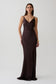 Woman wearing a dark brown v neck satin maxi dress.